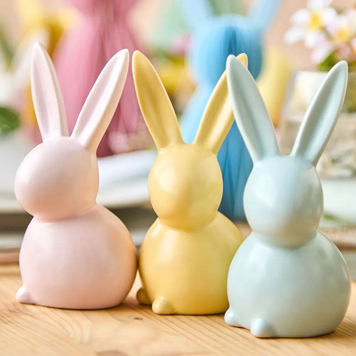 three mini ceramic bunnies in yellow, pink and blue