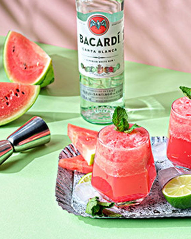 Refreshing watermelon mojito served in a clear glass, garnished with mint leaves and watermelon slices