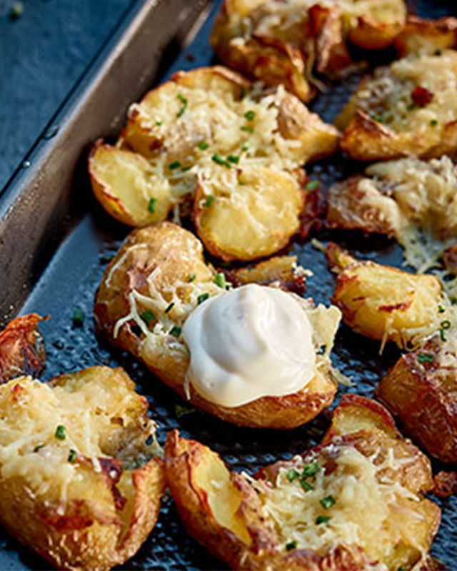 Crushed baby potatoes topped with melted Hegarty’s cheddar and herbs
