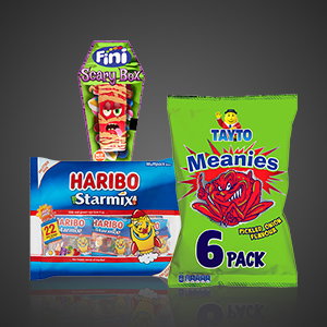 Halloween confectionery selection including a Haribo Starmix sharing pack, Tayto Meanies 6 pack and Fini Scary Box sweets against a dark background.