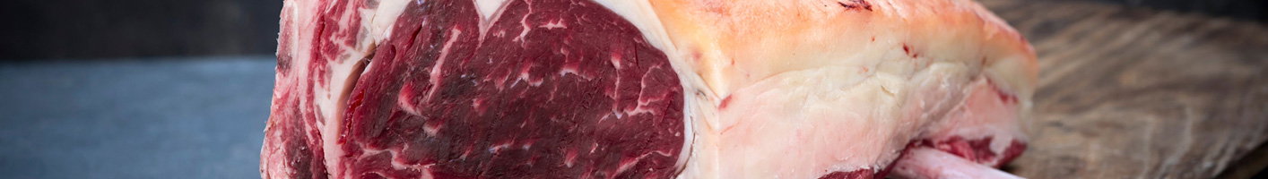 SSalt aged beef with distinct marbling patterns and fat distribution on a wooden surface.