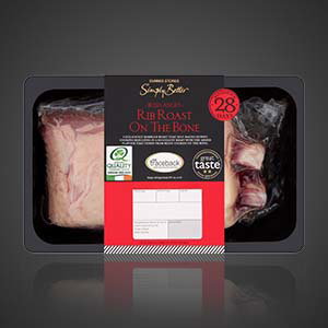 Simply Better Irish Angus rib roast on the bone on supermarket packaging, 28 days matured, showing a large cut of beef and bone section in a tray