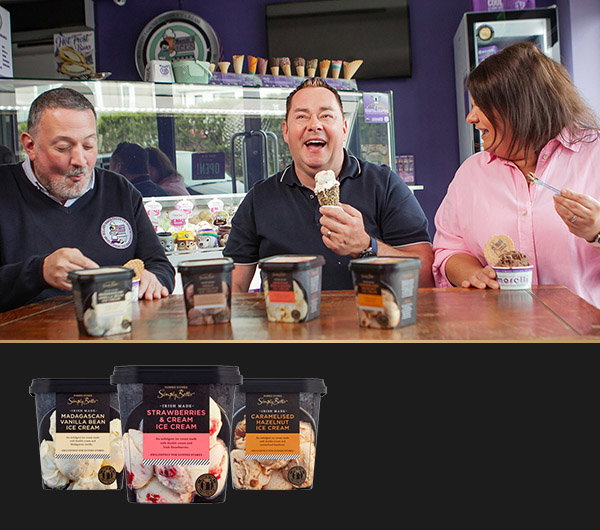 The Morelli siblings enjoy ice cream with Neven Maguire at a vibrant ice cream shop, with tubs of Vanilla, Strawberries & Cream, and Caramelized Peanut ice cream in front on a table.