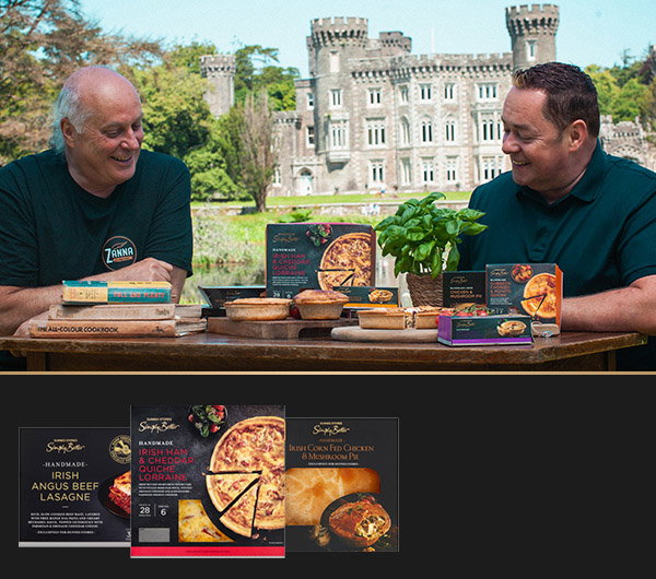 Owen Mullins sits with Neven Maguire at a table outdoors, surrounded by various meal products and cookbooks, with a castle in the background.