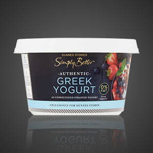 Tub of Dunnes Stores Simply Better authentic Greek yoghurt with 0% fat, featuring strawberries and blueberries on the packaging, on a dark background