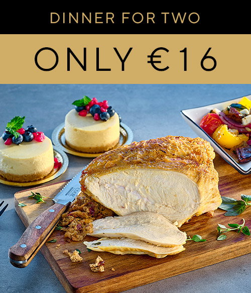 A delicious dinner for two featuring sliced roast chicken, creamy cheesecake desserts, and colourful veg, priced at &euro;16.