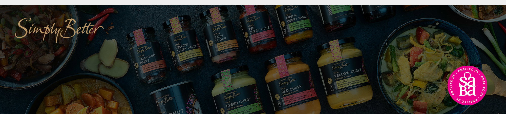 Assorted jars of sauces, curry pastes, and two bowls of prepared dishes are displayed on a dark surface with the "Saba" logo visible in the lower right corner.