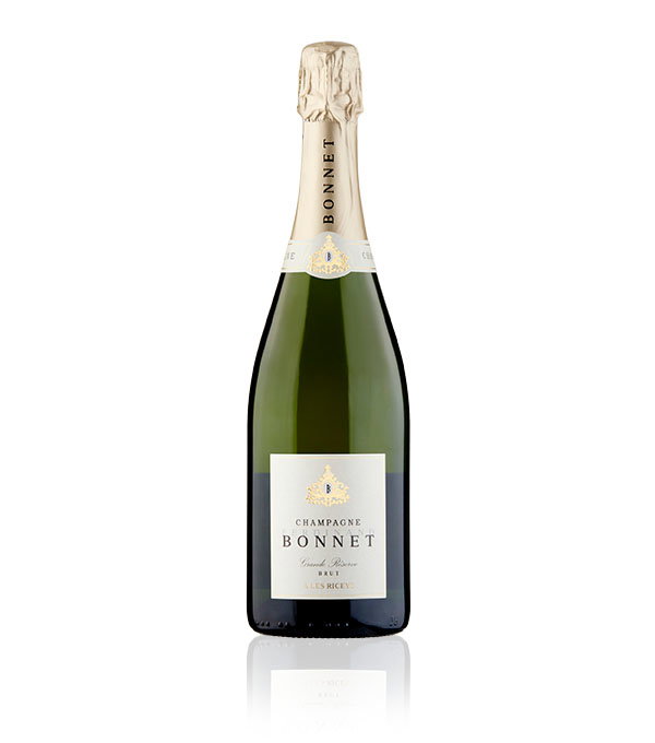 A champagne bottle labeled 'Bonnet' with a gold foil-wrapped top, elegant cream label, ornate emblem, and green glass reflecting sophistication.