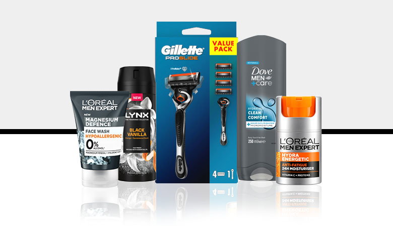 A collection of men's grooming products, including face wash, body wash, deodorant, and a razor, arranged attractively.