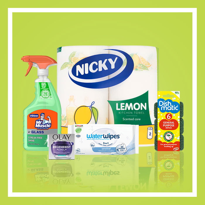 Household essentials promotion featuring Nicky Lemon kitchen towel, Mr Muscle Glass & Window cleaner, Olay Regenerist cream, WaterWipes sensitive wipes and Dishmatic refill sponges on a green background.
