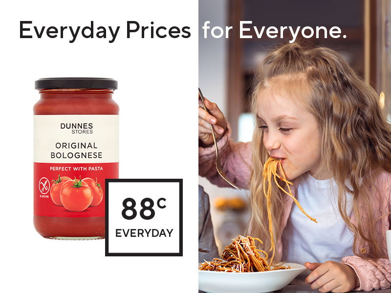 Jar of Dunnes Stores Original Bolognese sauce priced at 88 cents, alongside a girl enjoying spaghetti with sauce.