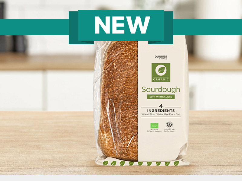 New Dunnes Stores Organic Sourdough soft white sliced loaf in packaging on a kitchen worktop with a green "NEW" banner above.