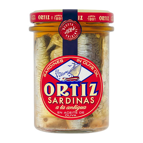 Jar of Ortiz sardines in olive oil with red lid and blue seal, a la antigua style